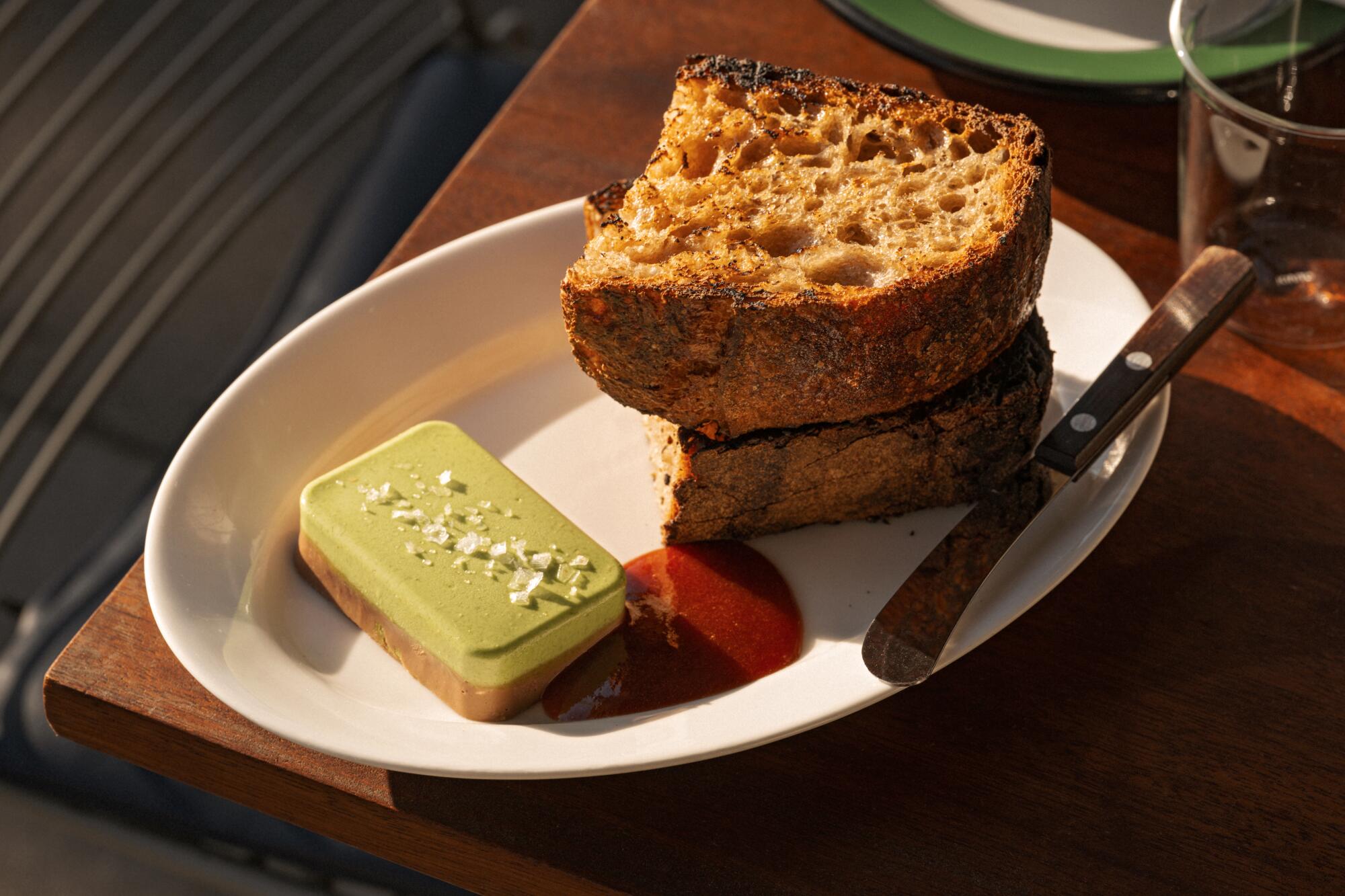 A plate of Jidori chicken liver with celery butter and hunks of sourdough bread at Sqirl in Los Angeles.