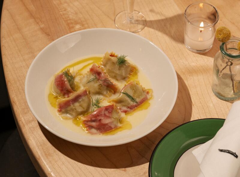 A Cosmo cocktail, pork with tortillas and grilled stone fruit, and striped beet agnolotti with smoked beet filling and ricotta whey butter sauce.