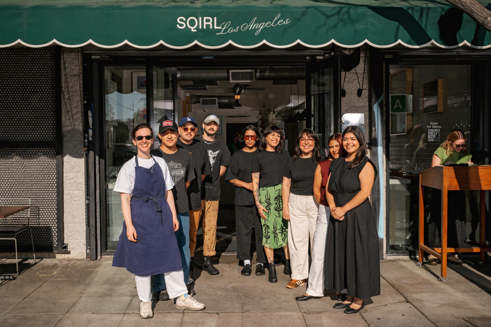 A team of chefs and managers in front of Sqirl.