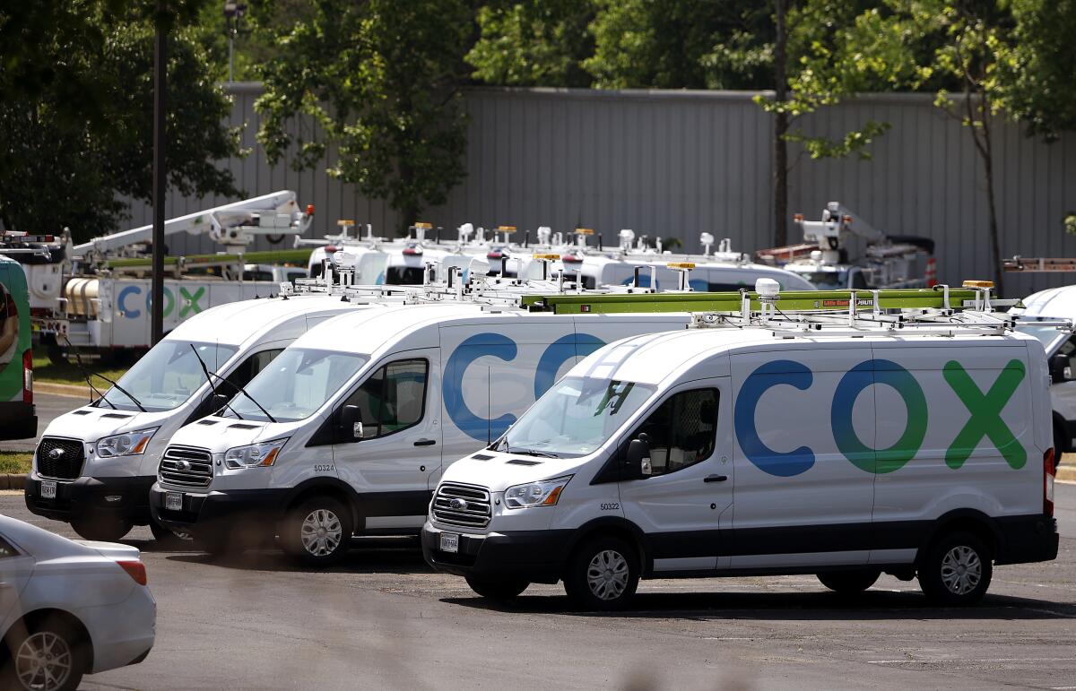 Cox utility trucks in Springfield, Virginia. (Photo by Kevin Dietsch/Getty Images)