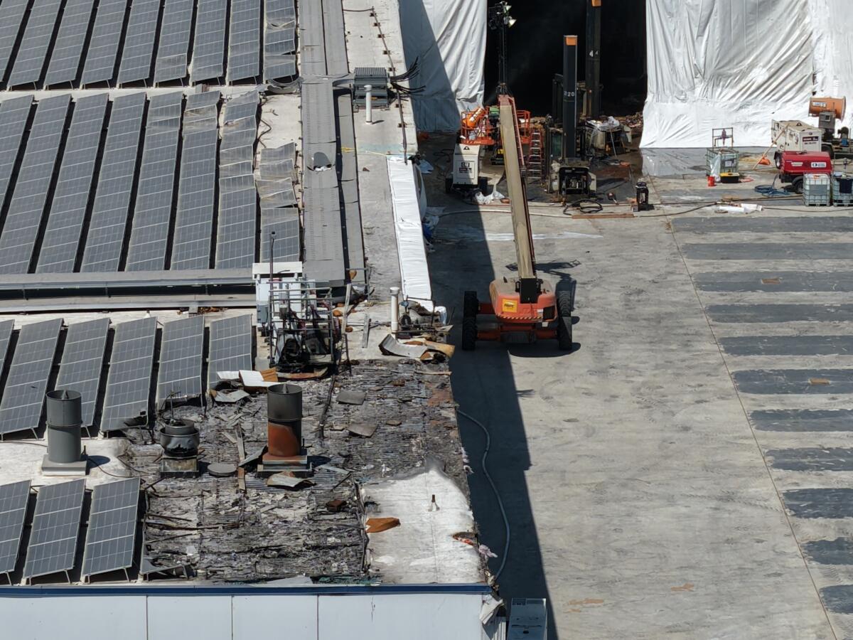 Construction crews continue cleanup efforts following a large fire