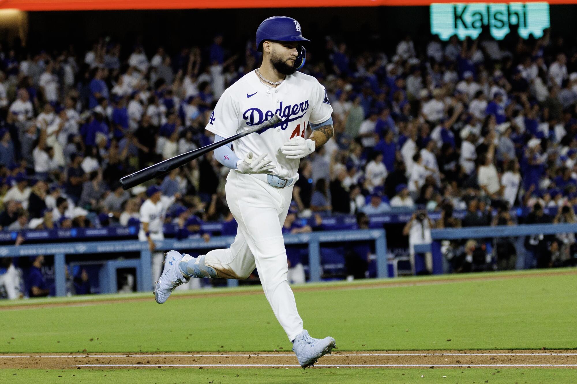 Andy Pages flips his bat after hitting a solo home run against the Brewers at Dodger Stadium.
