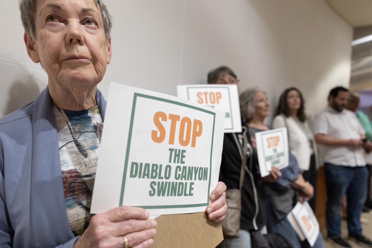 Jane Swanson, a board member of the San Luis Obispo Mothers for Peace, waits to speak during public comments