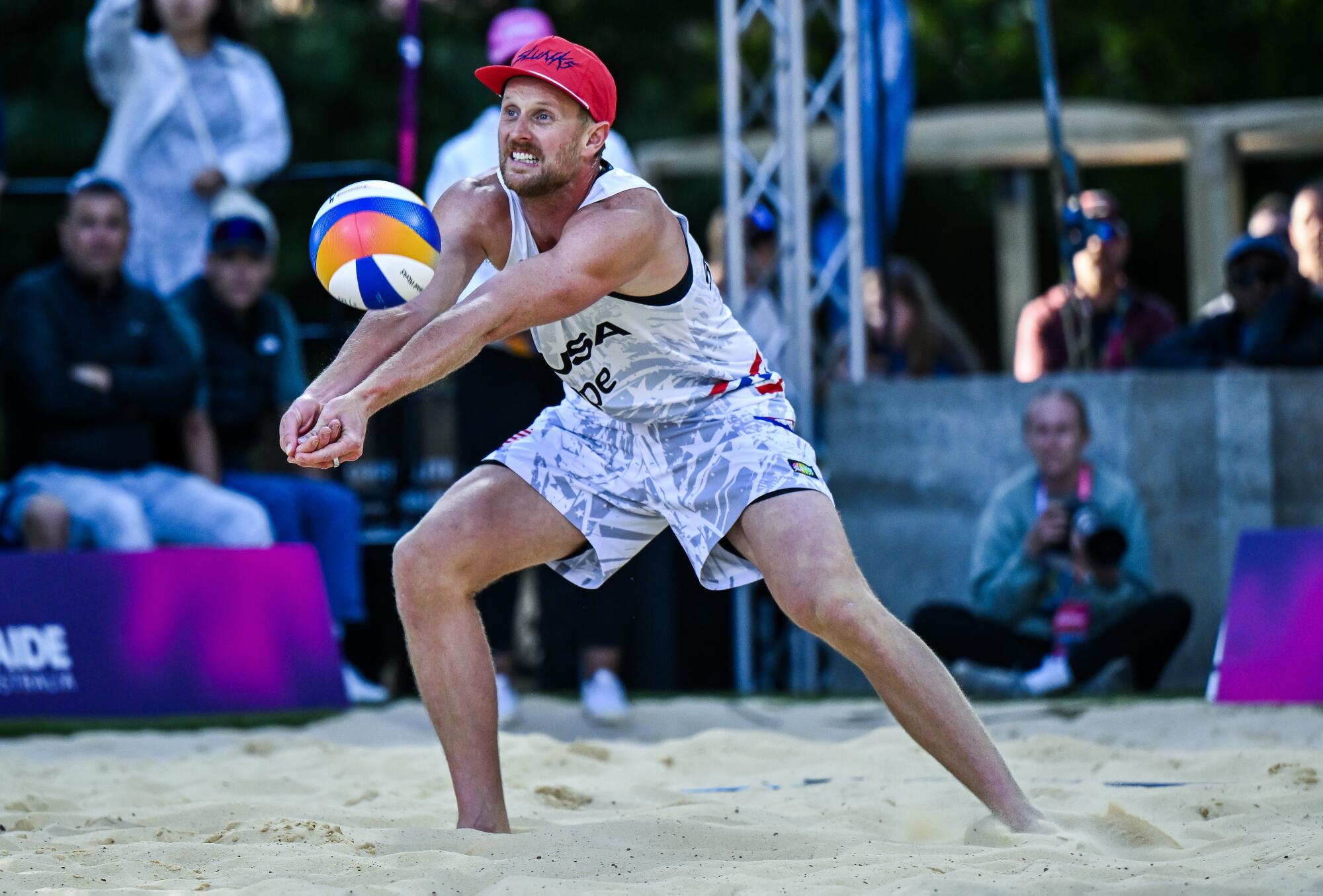 American Chaim Schalk digs the ball during a match against Cubans Nosien Diaz Amaro and Jorge Luis Alayo Moliner.