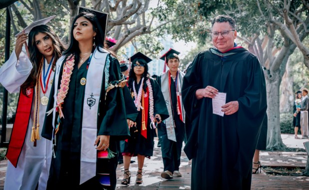 Richard Barrera, the San Diego Unified school board president, stands with graduates, at the East Village H.S. graduation ceremony at City College on Friday, June 5, 2026 in San Diego. (Photo by Sandy Huffaker, Contributing Photographer)