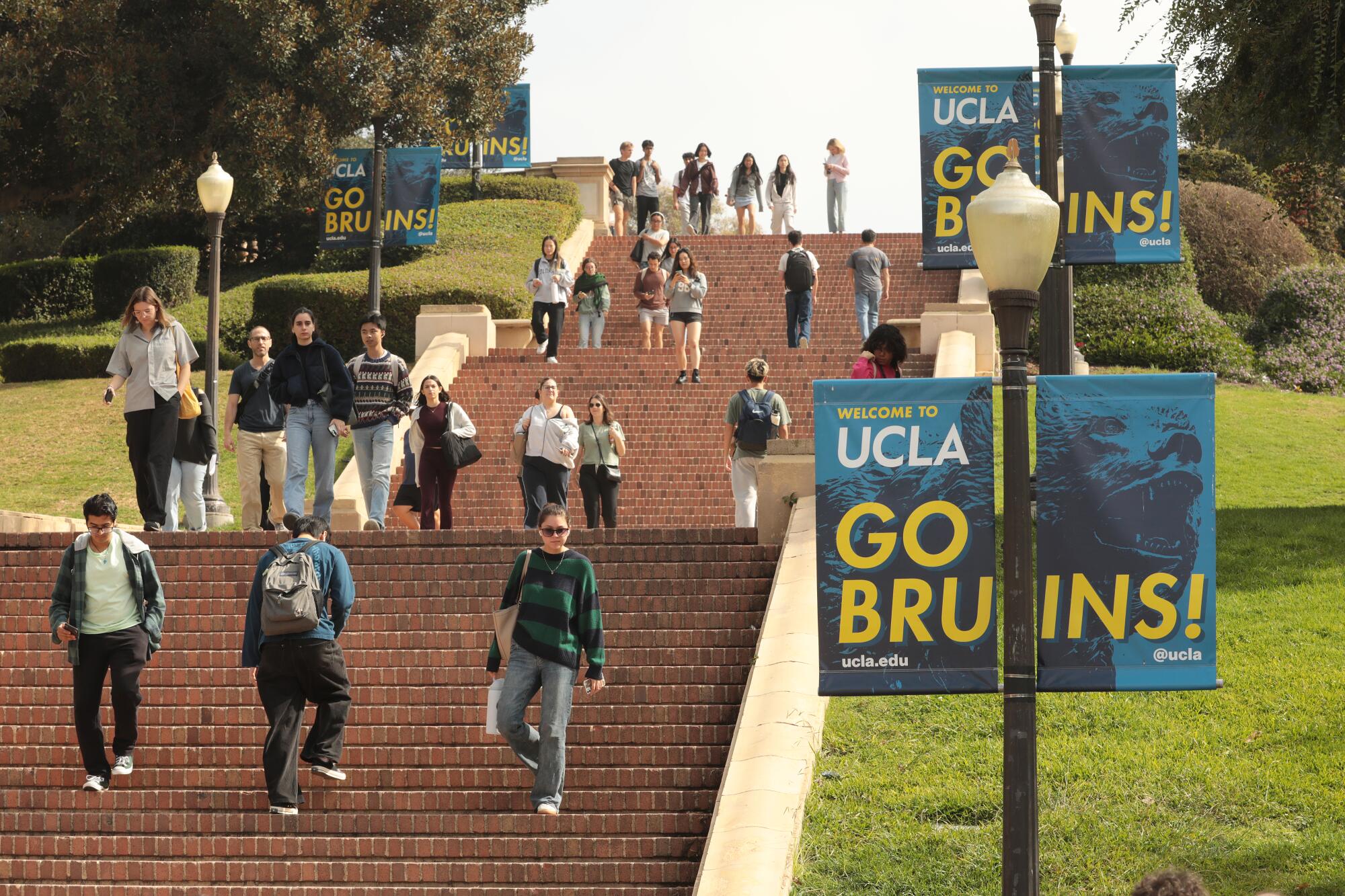 UCLA students walk up and down stairs on a campus that features many hills. 