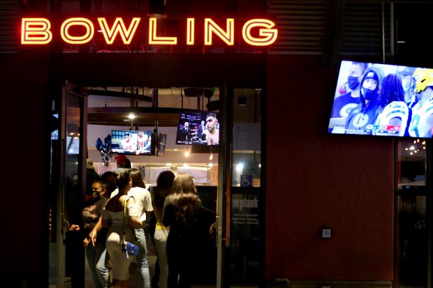 Customers walk in and out of the Plank bowling venue in Jack London Square in Oakland in 2020. (Ray Chavez/Bay Area News Group)