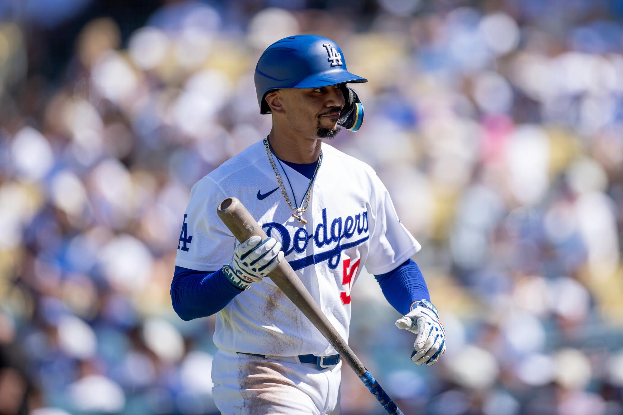 Dodgers shortstop Mookie Betts walks back to the dugout after striking out in the seventh inning.