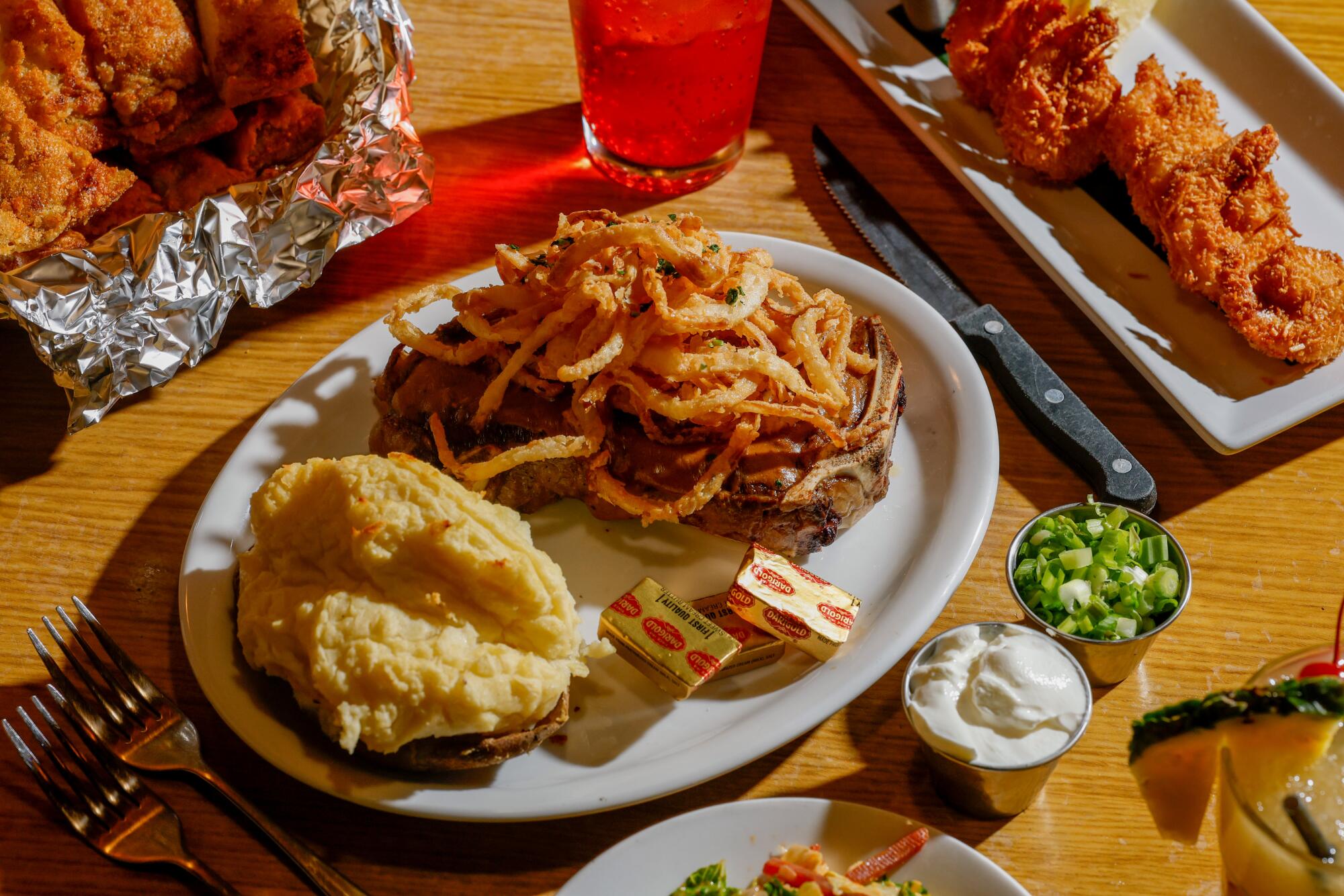 New York steak with crispy fried onions and a twice baked potato at Damon's Tiki Steak House in Glendale.