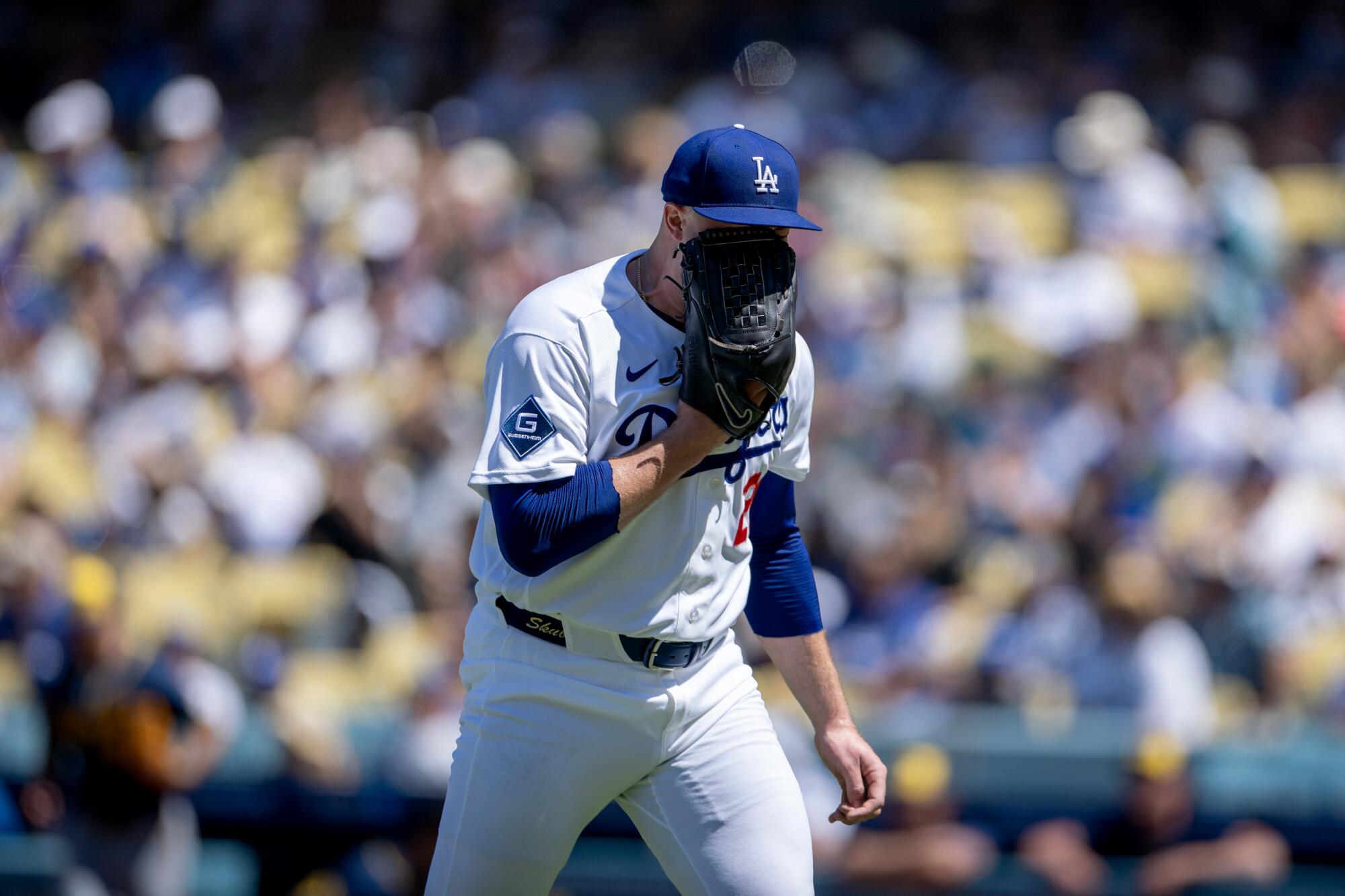 Dodgers pitcher Tarik Skubal yells into his glove while walking off the field during the fifth inning.