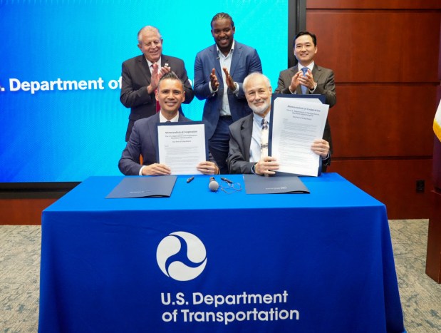 Port of Long Beach CEO Noel Hacegaba (bottom left) and U.S. Department of Transportation Maritime Administrator Stephen Carmel (bottom right) sign the first-ever partnership agreement between a port and the U.S. Maritime Administration to advance work on small modular reactor technology for maritime uses. Looking on, back row from left, are Long Beach Board of Harbor Commissioners President Frank Colonna, BlueCore Energy Founder and CEO Kofi Asante, and American Association of Port Authorities President and CEO Sang Yi. (Photo Courtesy of the Port of Long Beach)
