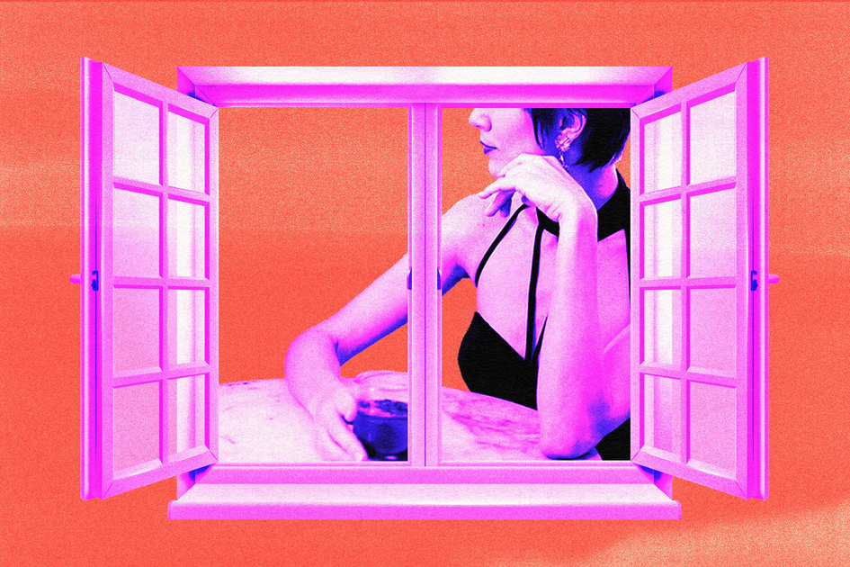 A woman in a black halter top rests her chin on one hand and holds a glass with the other, seen through an open window against an orange background.