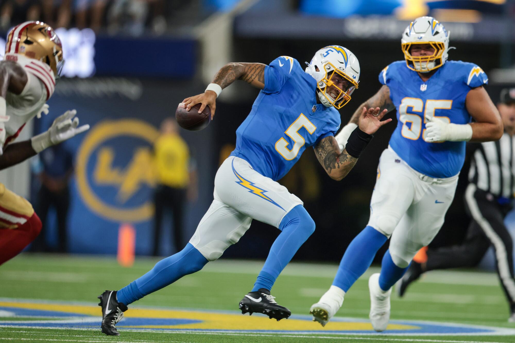 Chargers quarterback Trey Lance scrambles against the 49ers in the first half Thursday.