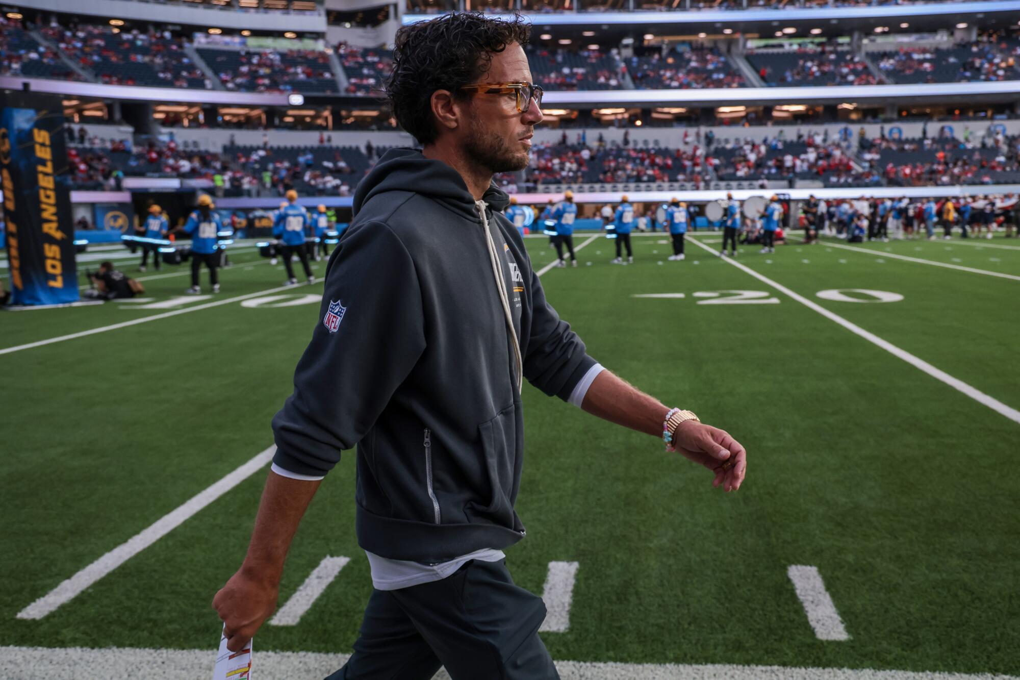 Chargers offensive coordinator Mike McDaniel walks the sideline before Thursday's preseason game.