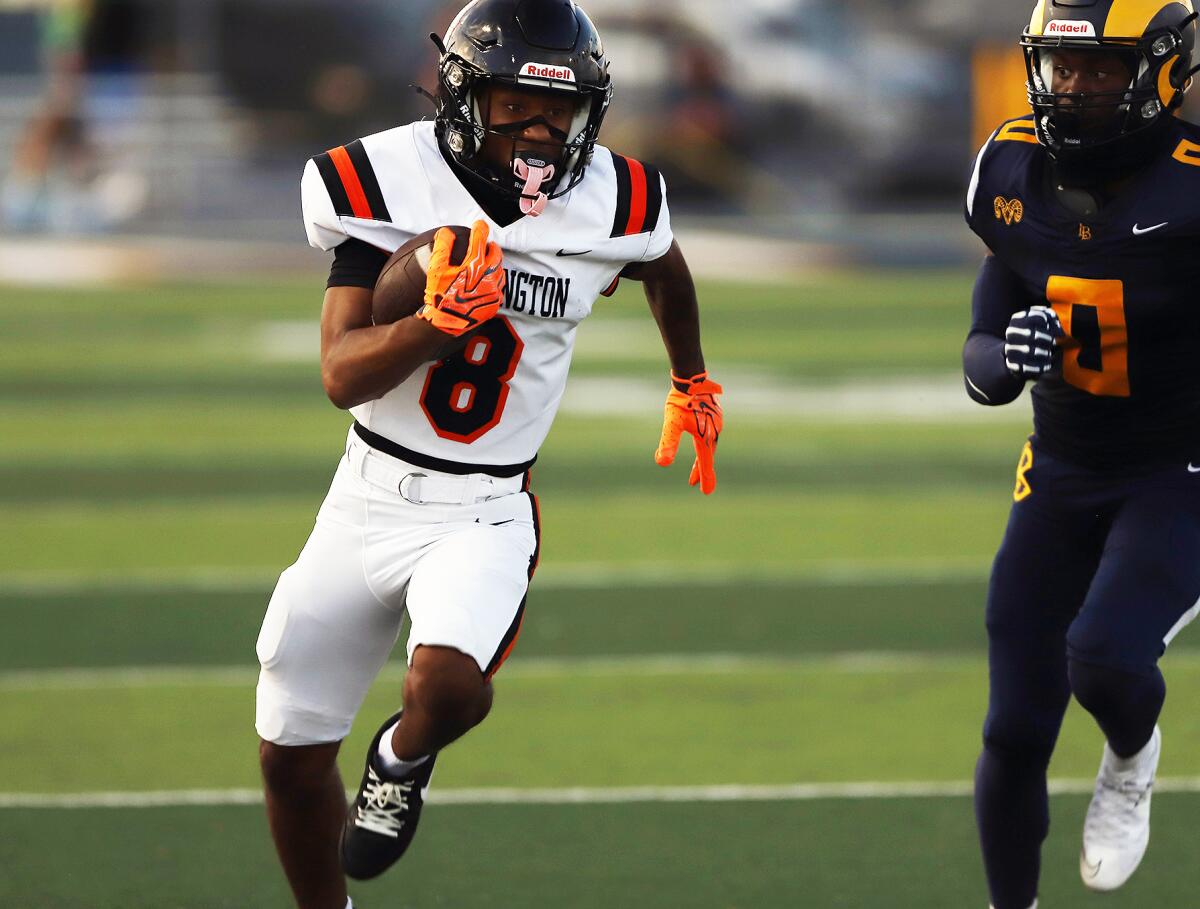 Huntington Beach's Skylar Robinson (8) advances the ball against Millikan on Thursday.