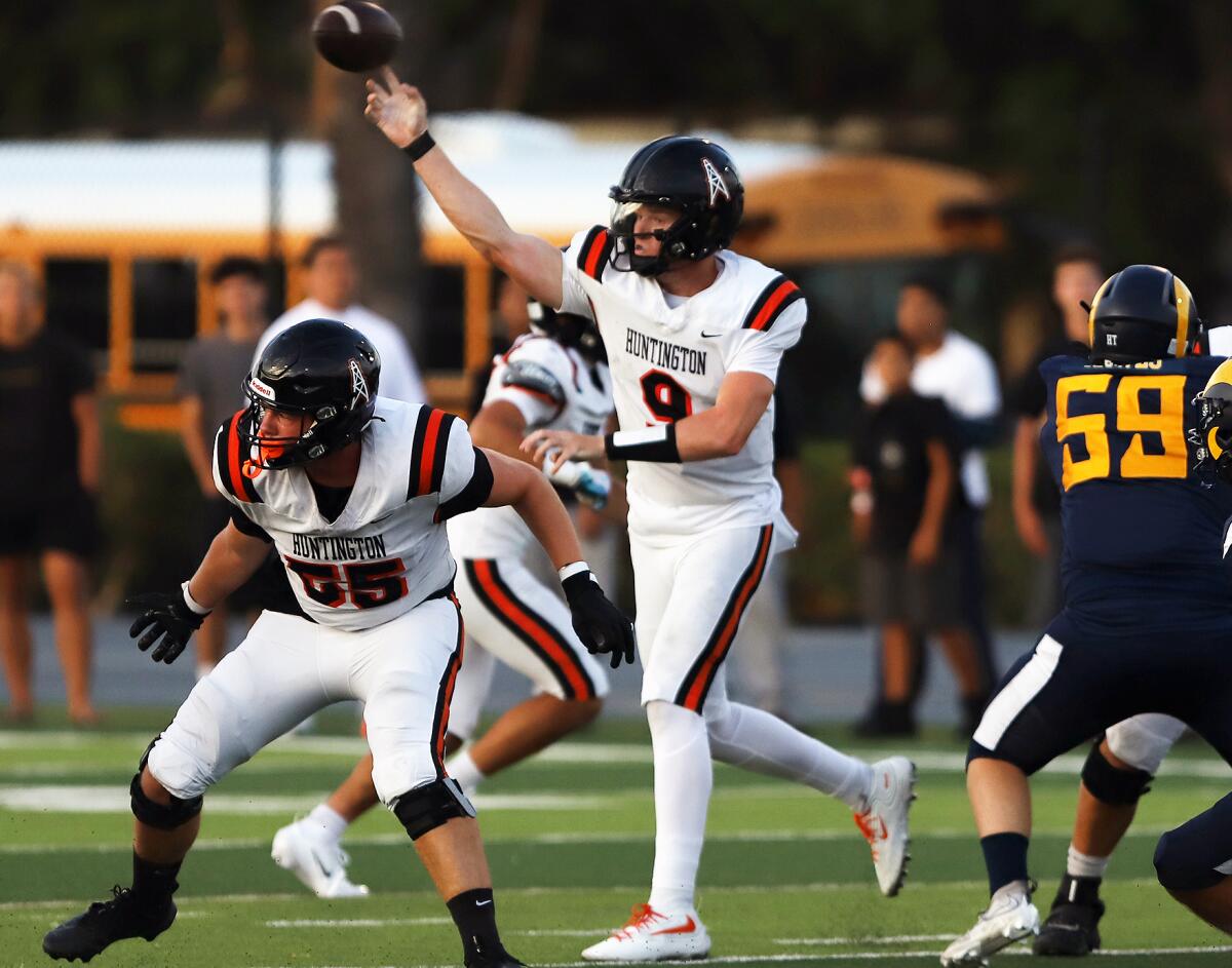 Huntington Beach quarterback Brady Edmunds (9) passes against Millikan in a nonleague opener.