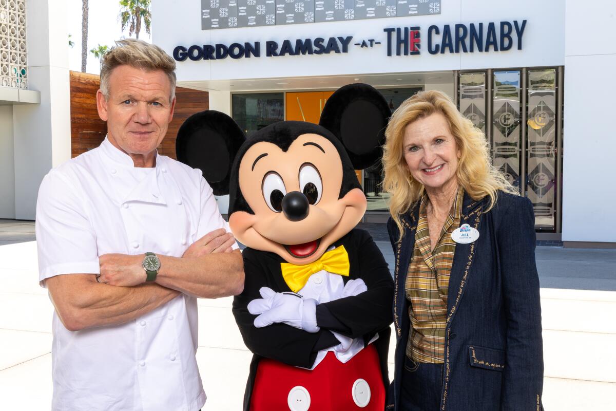 Chef Gordon Ramsay poses with Mickey Mouse and Disneyland Resort President Jill Estorino at Gordon Ramsay at The Carnaby