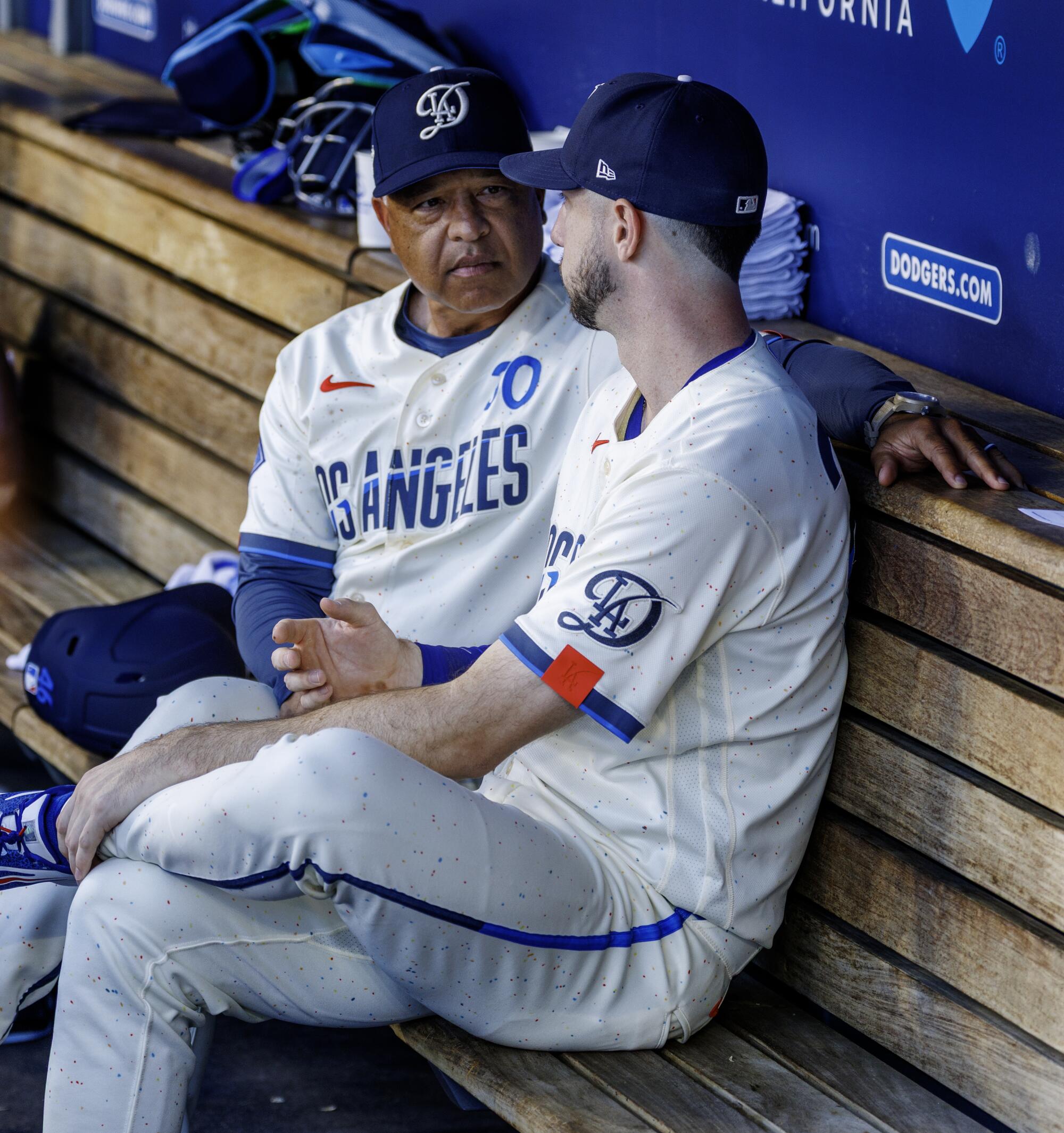 Dodger Kyle Tucker talks with manager Dave Roberts in the dugout on Aug. 15.
