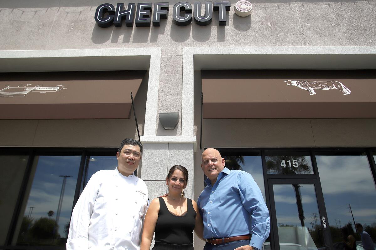 Head Chef Masakazu "Masa" Ode, left, and owners Dani and Tony Fasulo pose for a picture in front of Chef Cut Meat House. 