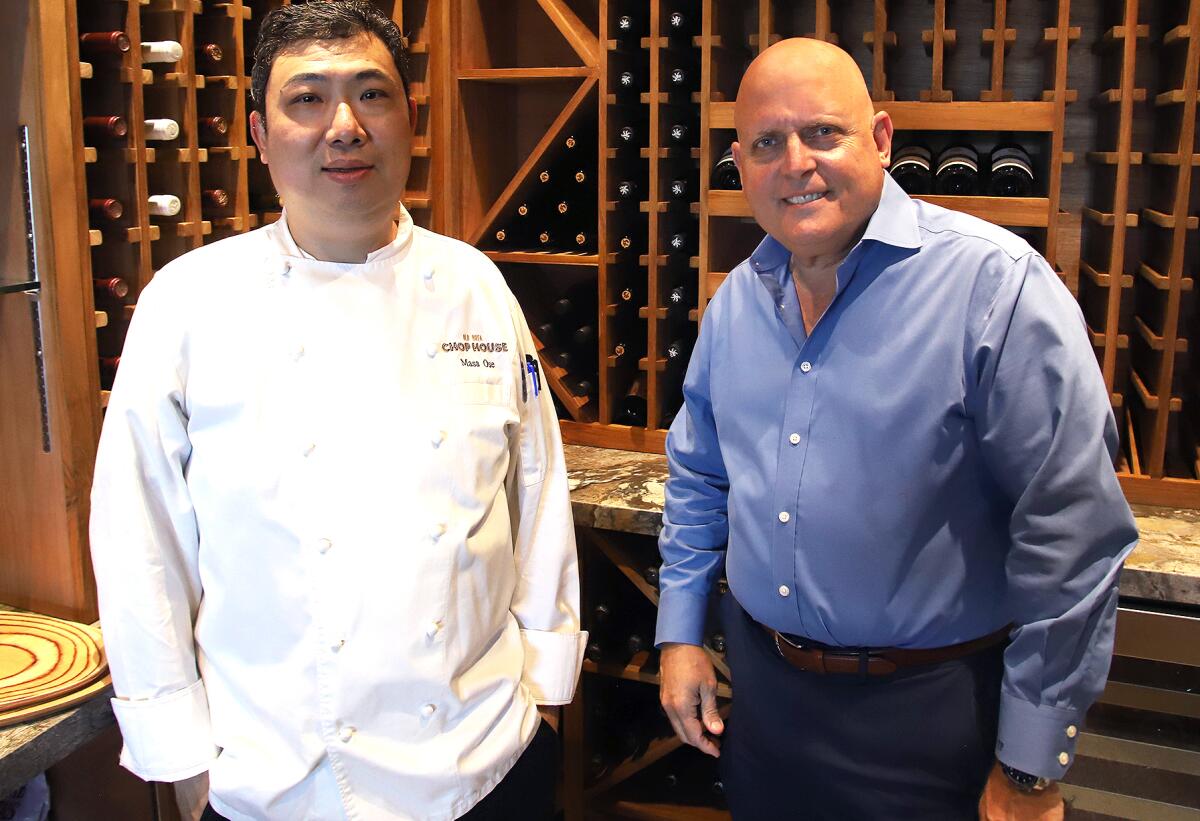 Chef Cut Meat House's chef Masakazu "Masa" Ode, left, and owner Tony Fasulo pose for a picture in the wine vault.