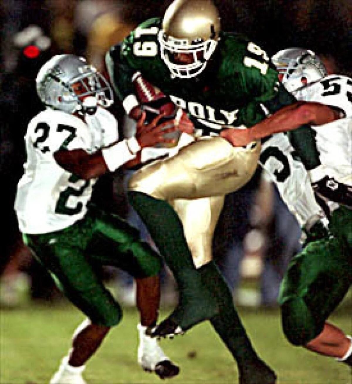 In 2001, Marcedes Lewis tries to get past De La Salle defenders.