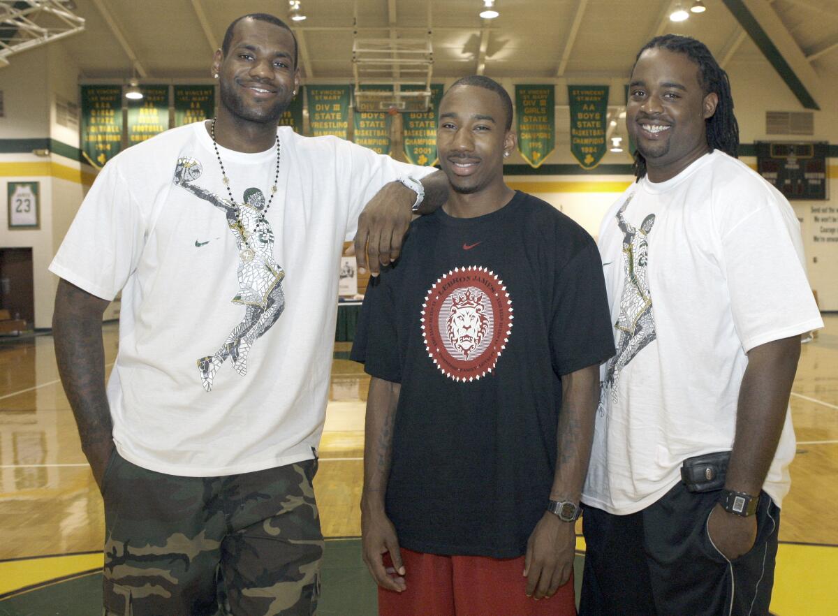 Former Akron St. Vincent-St. Mary High School basketball teammates, from left, LeBron James, Dru Joyce III, and Willie McGee