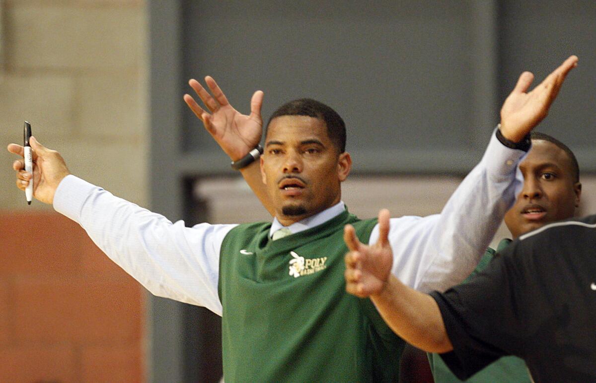 Long Beach Poly coach Sharrief Metoyer throws his hands up in an act of exasperation along the sidline.