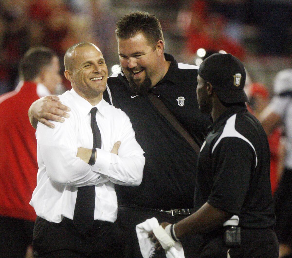 Servite coach Troy Thomas, in 2009, is congratulated by assistant coach Ken Foersch, now the president of Crespi.