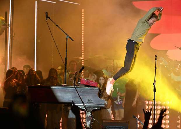 Andrew McMahon leaps from the keyboard as he performs his last song of the night while kids from the families of band members gather around the piano for the Three Pianos tour, August 22, 2026, at the new F&M Bank Amphitheater of Long Beach. (Photo by Steven Georges, Contributing Photographer)