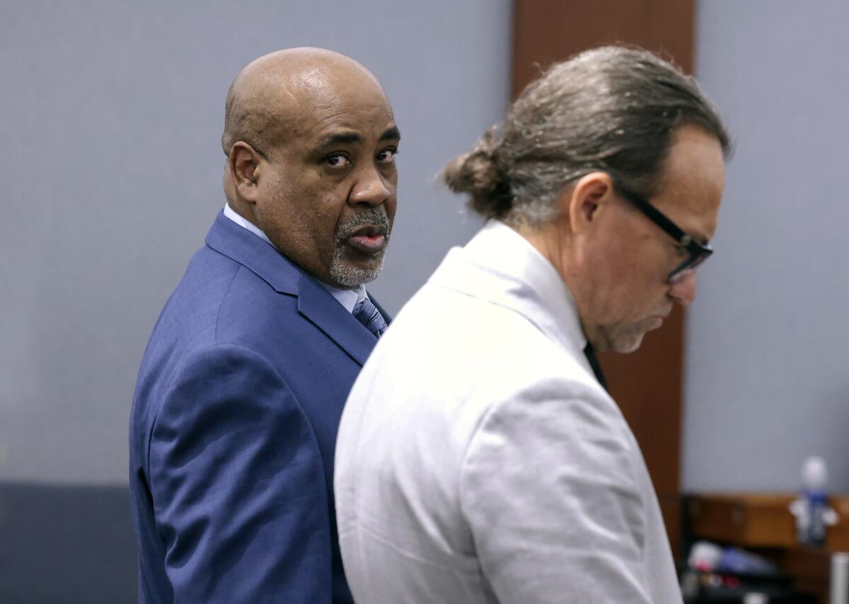 Duane Davis looks up as he stands by an attorney.