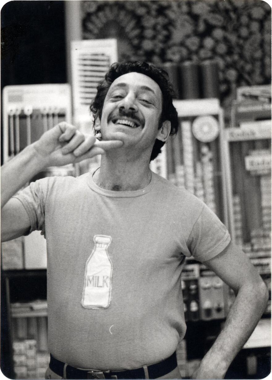 Harvey Milk posing in milk bottle t-shirt in Castro Camera.