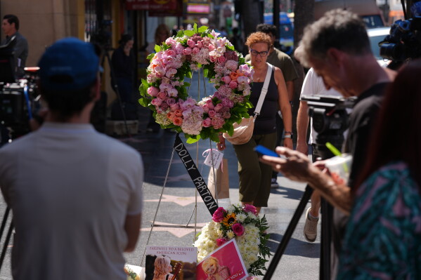 A wreath stands over Dolly Parton's star on the Hollywood Walk of Fame Tuesday, Aug. 25, 2026, in Los Angeles. (AP Photo/Chris Pizzello)
