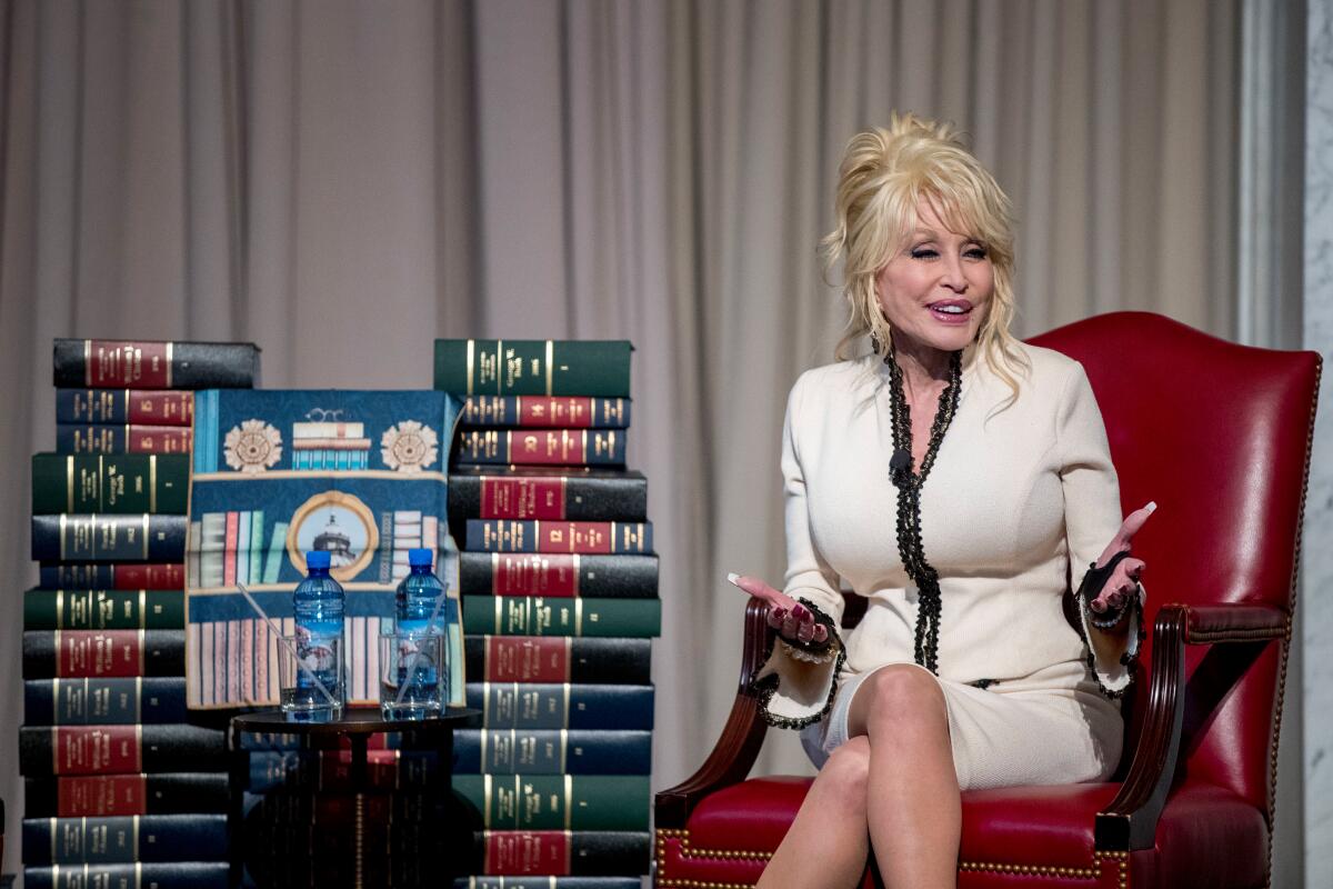 Dolly Parton speaks at an event where her organization, Imagination Library, 