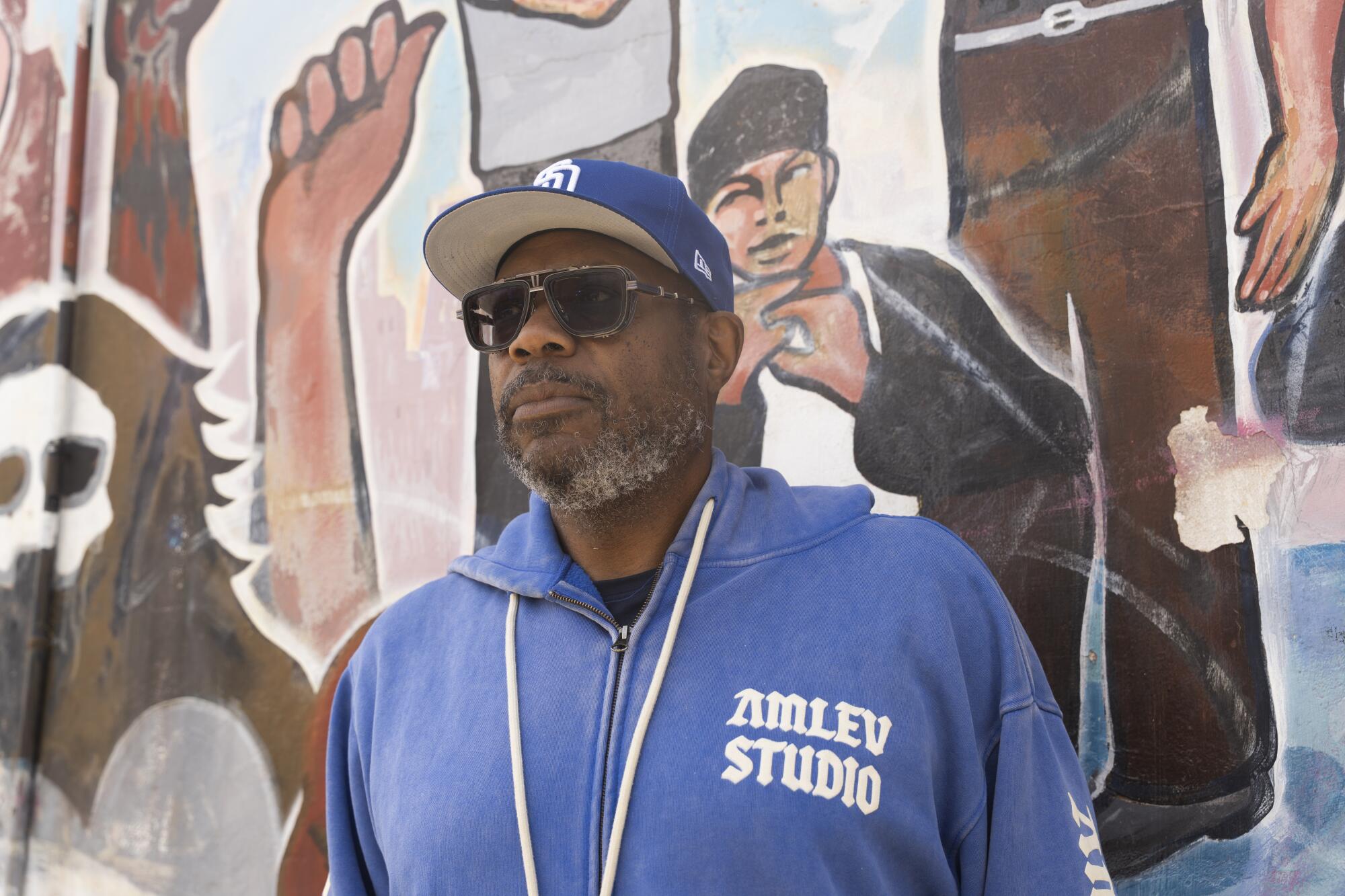 Author Andre Hardy in San Diego near Chicano Park's iconic murals, which show up in his debut mystery novel.