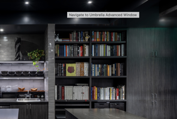A wide shot of a large floor to ceiling bookcase with shelves full of books, inside a modernist restaurant.