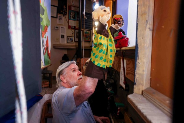 Children's Fairyland puppet theater director Randal Metz works on a live puppet show backstage in Oakland, Calif., Thursday, June 27, 2026. Metz, who said he started at age 10, has been a puppeteer for 57 years. (Ray Chavez/Bay Area News Group)