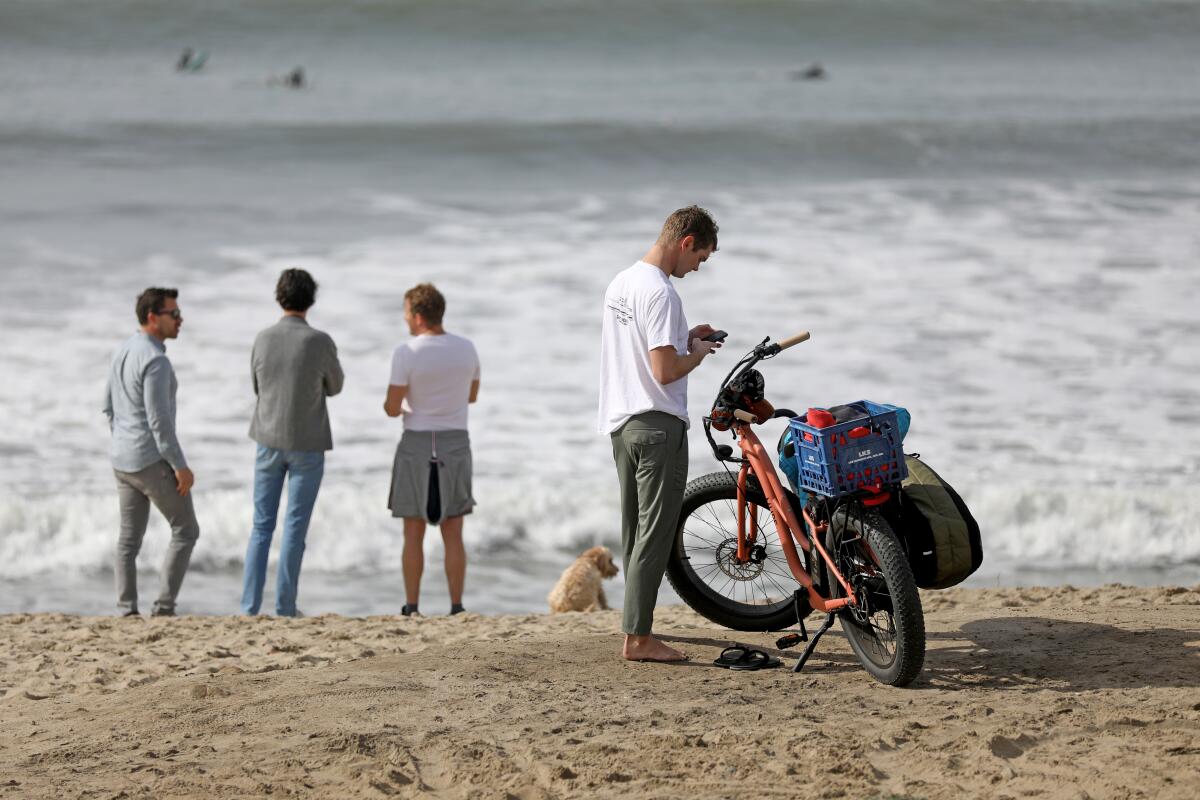 A surfer with an electric bike (e-bike) at Trestles Thursday, Jan. 12, 2023 in San Clemente, CA. 