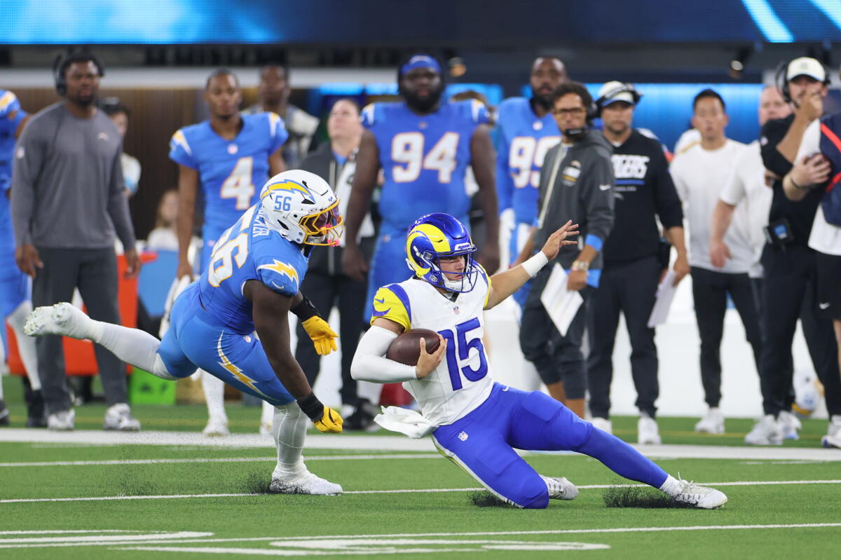 Rams quarterback Ty Simpson slides in front of Chargers linebacker Nadame Tucker during the first half Thursday.