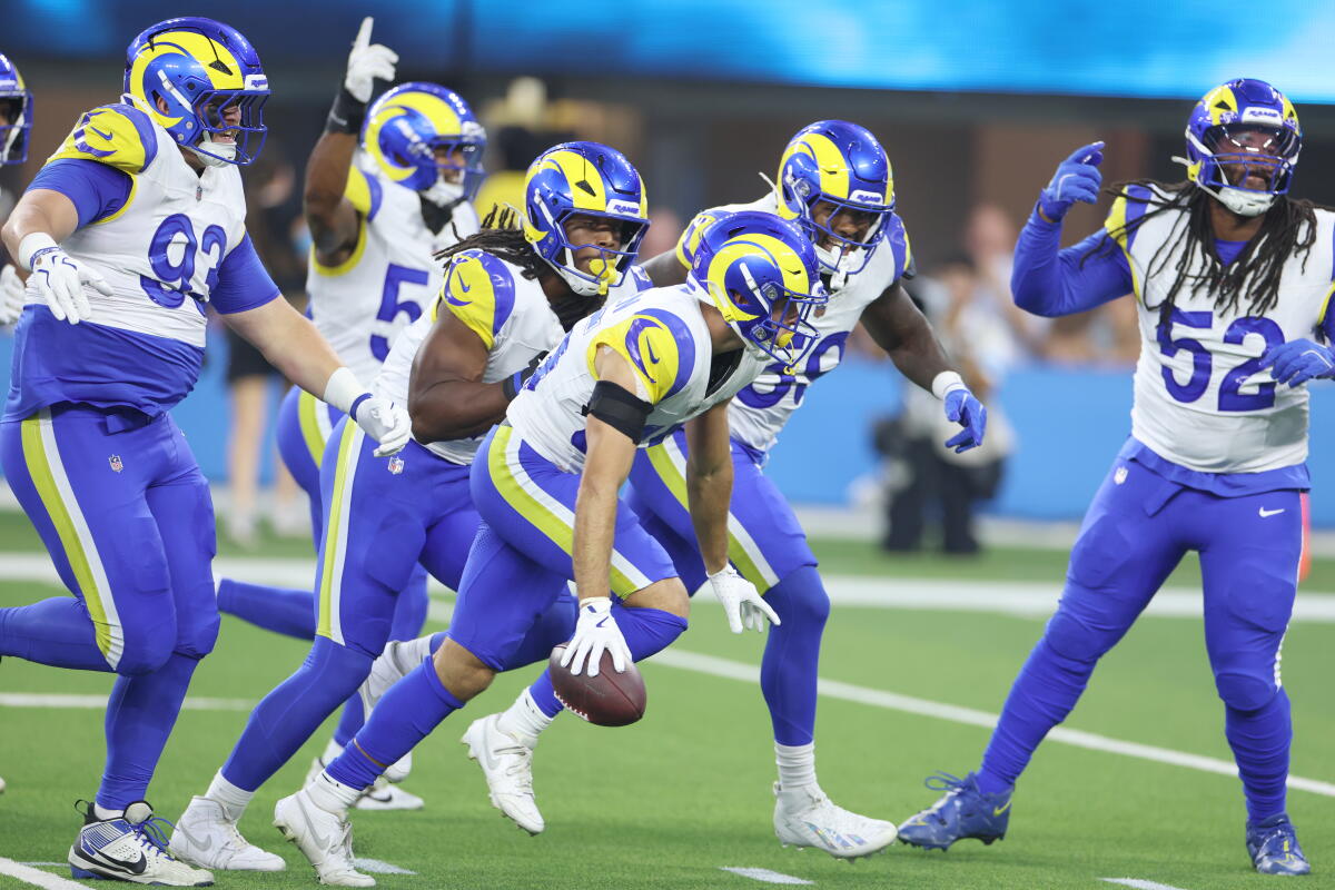 Rams safety Nick Andersen celebrates with teammates after recovering a fumble by Chargers quarterback Justin Herbert.