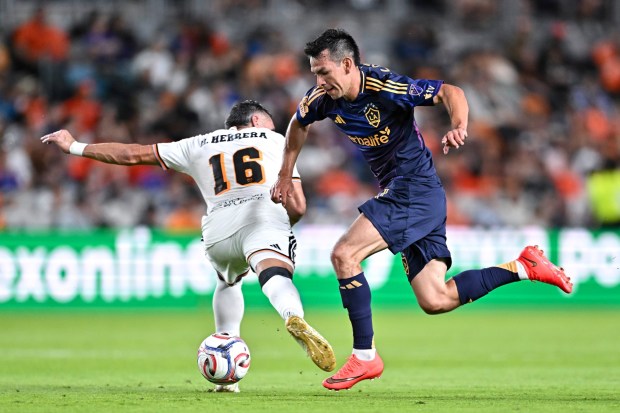 The Galaxy's Hirving 'Chucky' Lozano, right, controls the ball as Houston Dynamo FC's Héctor Herrera defends during the second half on Saturday, Aug. 15, 2026, in Houston. (Photo by Maria Lysaker/Getty Images)