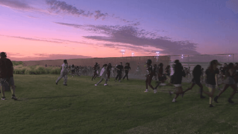 Fans flee after gunshots rang out during Independence High School's football game on Friday, August 21, in Bakersfield, CA. PHOTO: KBAK/KBFX