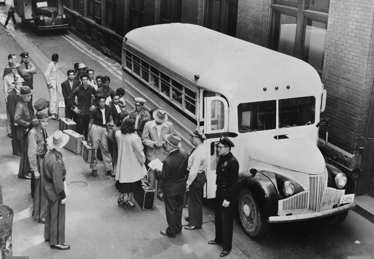 A 1949 photo of undocumented immigrants boarding a bus for deportation to Mexico.