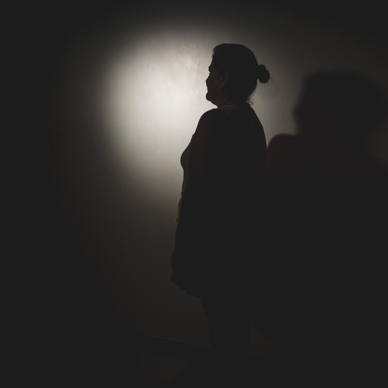 a woman poses for an anonymous portrait