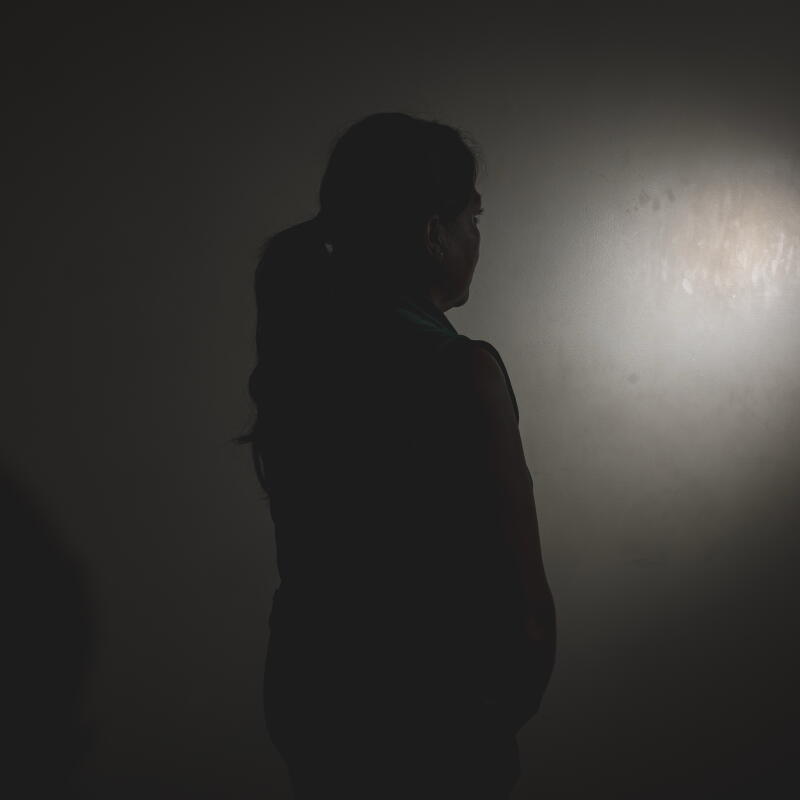 a woman poses for an anonymous portrait