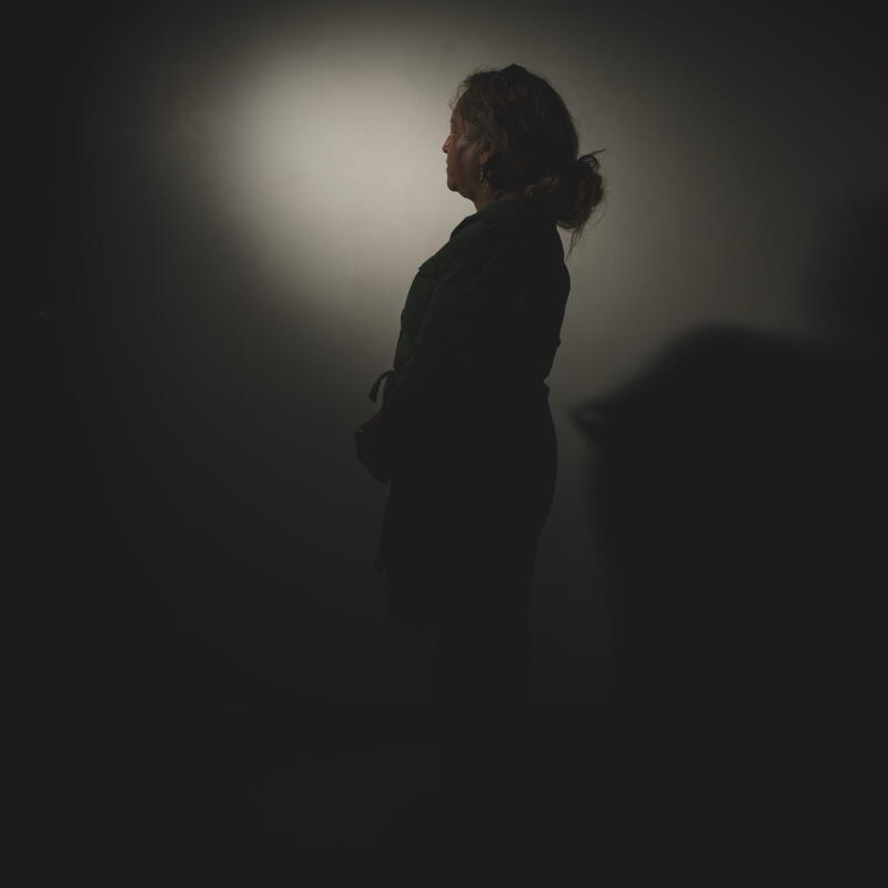 a woman poses for an anonymous portrait