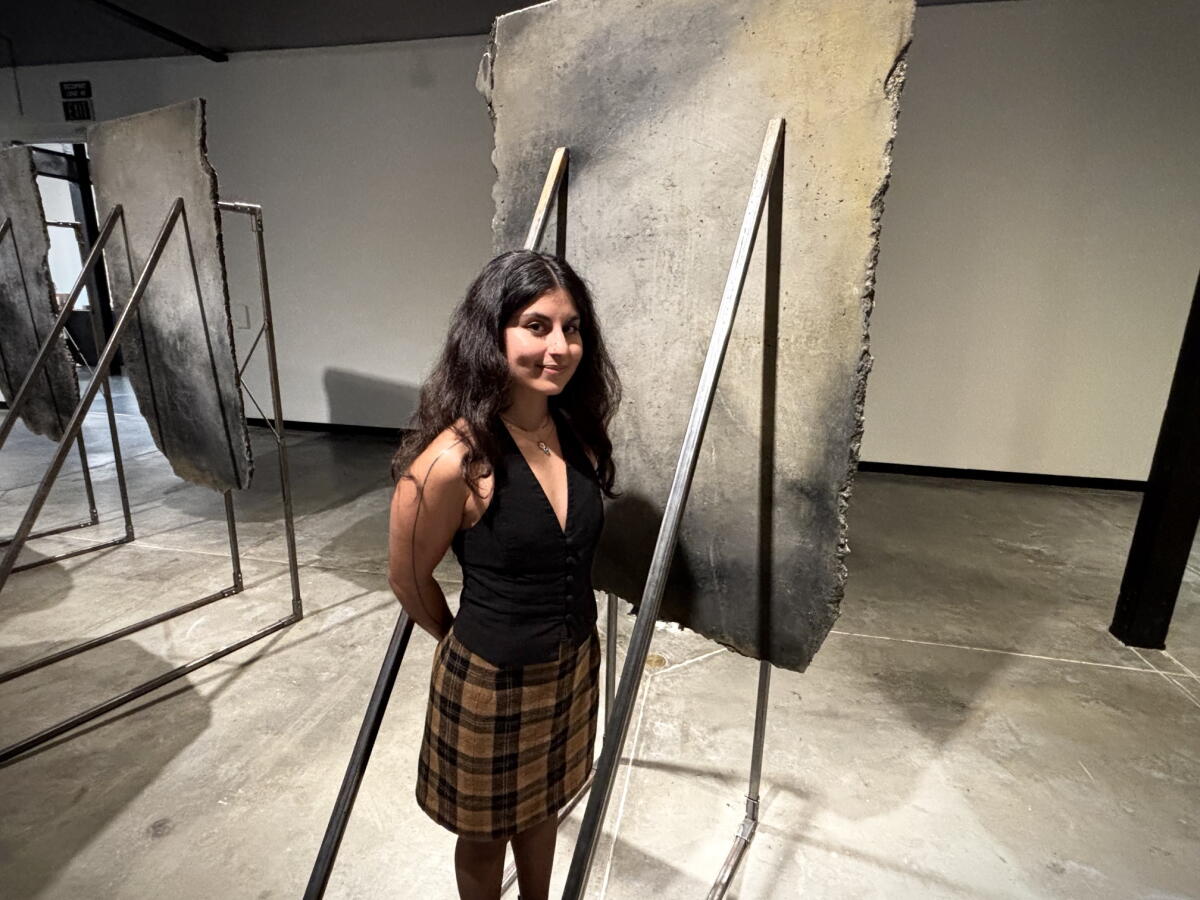 Artist Aryana Polat stands with her installation, "A Boundary Meant to Separate" in Santa Ana.