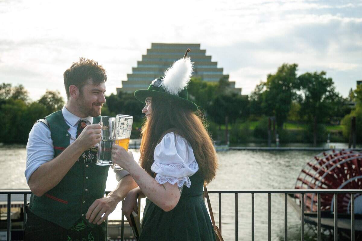 Ethan Maiuro, left, and his girlfriend Zoe Smith clink their glasses at the grand opening of Der Biergarten Waterfront in Old Sacramento on Friday, Aug. 7, 2026.