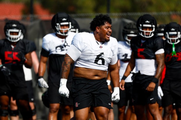 San Diego State defensive tackle Malachi Finau (6) chants with teammates during preseason training camp at SDSU's practice fields. (Meg McLaughlin / The San Diego Union-Tribune)