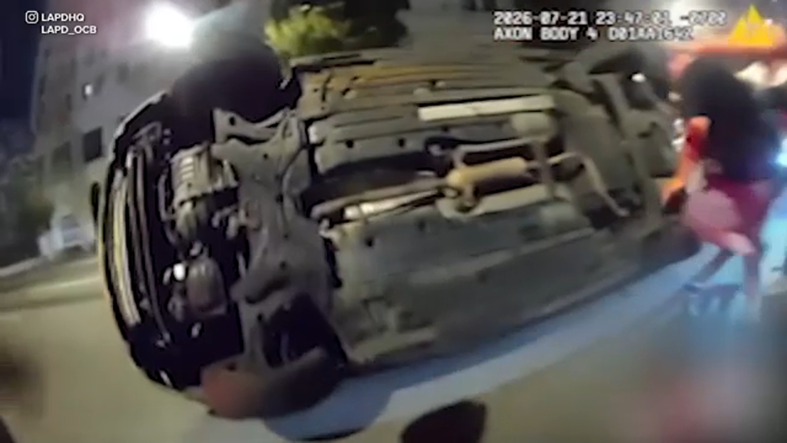 Los Angeles police bodycam video shows dramatic rescue of person pinned under car after crash