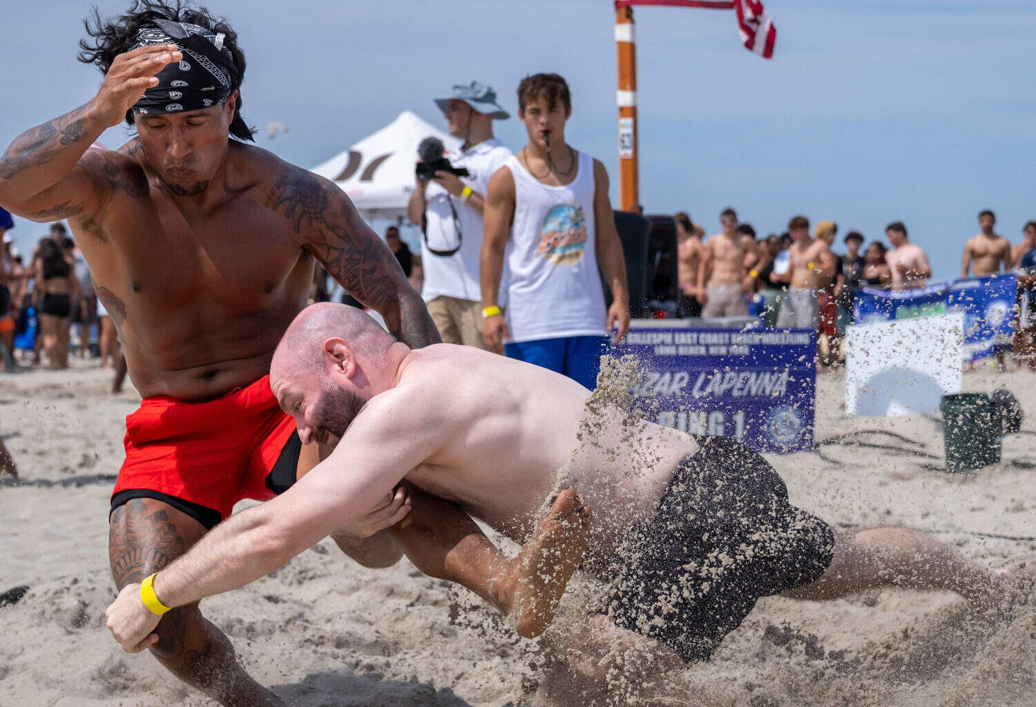 Edison Tigre, left, and Greg Richman tangled at the Jones & Gillespie East Coach Beach Wrestling Tournament last Saturday.